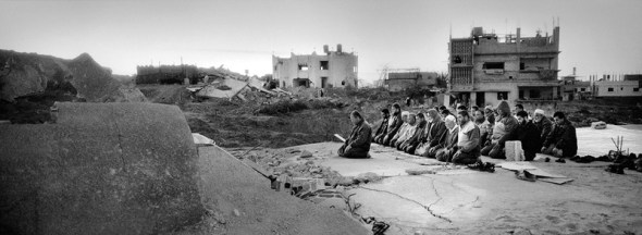 Gaza Strip January 24, 2009, East Jabalya, Hai-Al-Salam district, Palestinians offer Friday noon prayers on the top of a destroyed mosque.